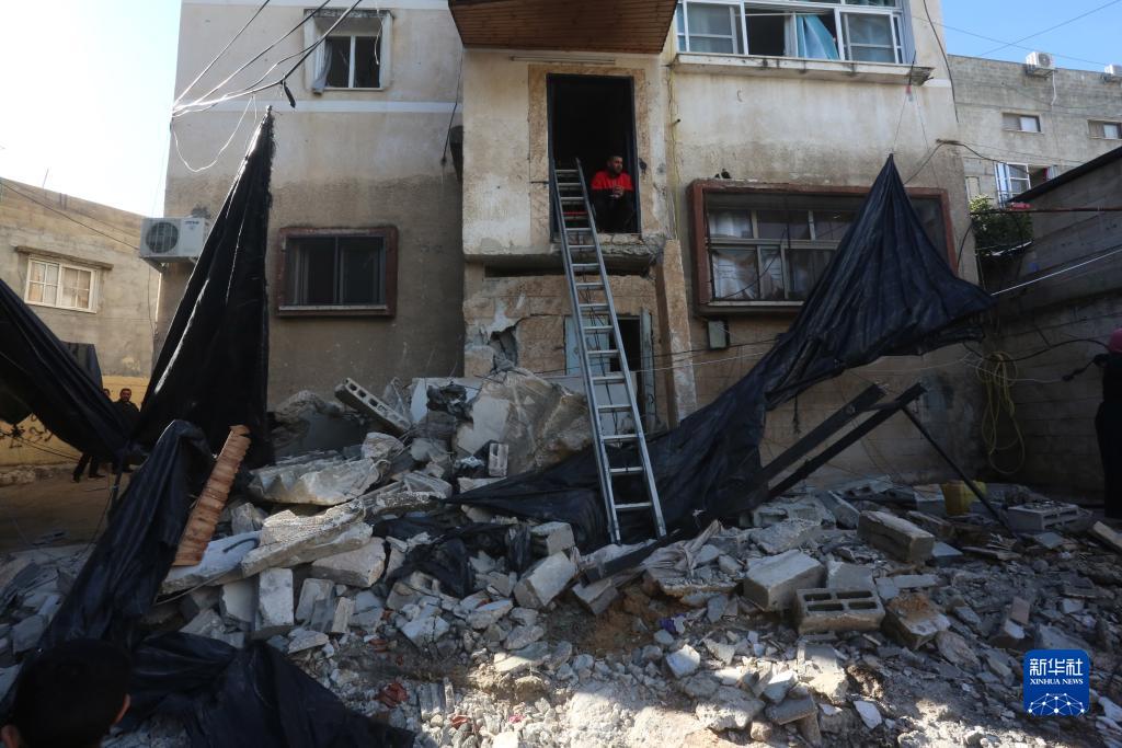 12月17日，在約旦河西岸城市圖勒凱爾姆附近的一處難民營，人們查看在沖突中損毀的房屋。新華社發(fā)（尼達(dá)爾·艾仕塔耶?dāng)z）