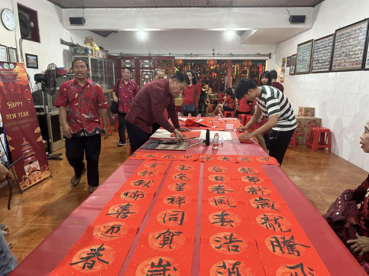 茍皓東為華人朋友現(xiàn)場寫春聯(lián)送福字。巴陵康孔子學(xué)院供圖