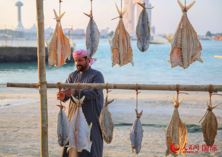    手工藝者展示如何晾曬魚干。人民網(wǎng) 塔里克·易卜拉欣攝