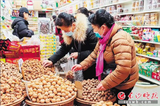 　　在長沙南門口菜市場附近的一家炒貨店內(nèi)，市民正在選購年貨。　　長沙晚報全媒體記者 范宏歡 攝