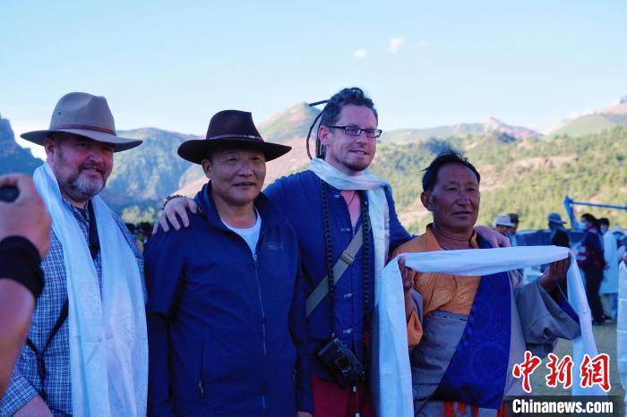 圖為當(dāng)?shù)孛癖娕c外籍?dāng)z影師合影留念?！●R銘言 攝